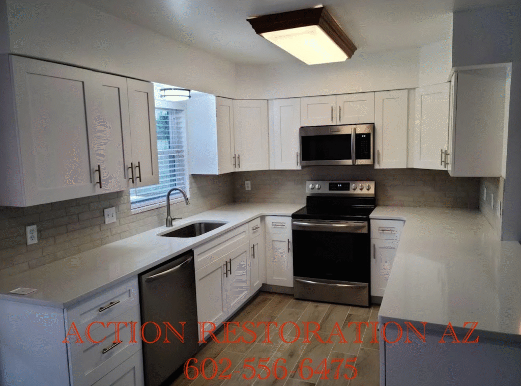 Bright modern kitchen with white cabinets and black appliances.