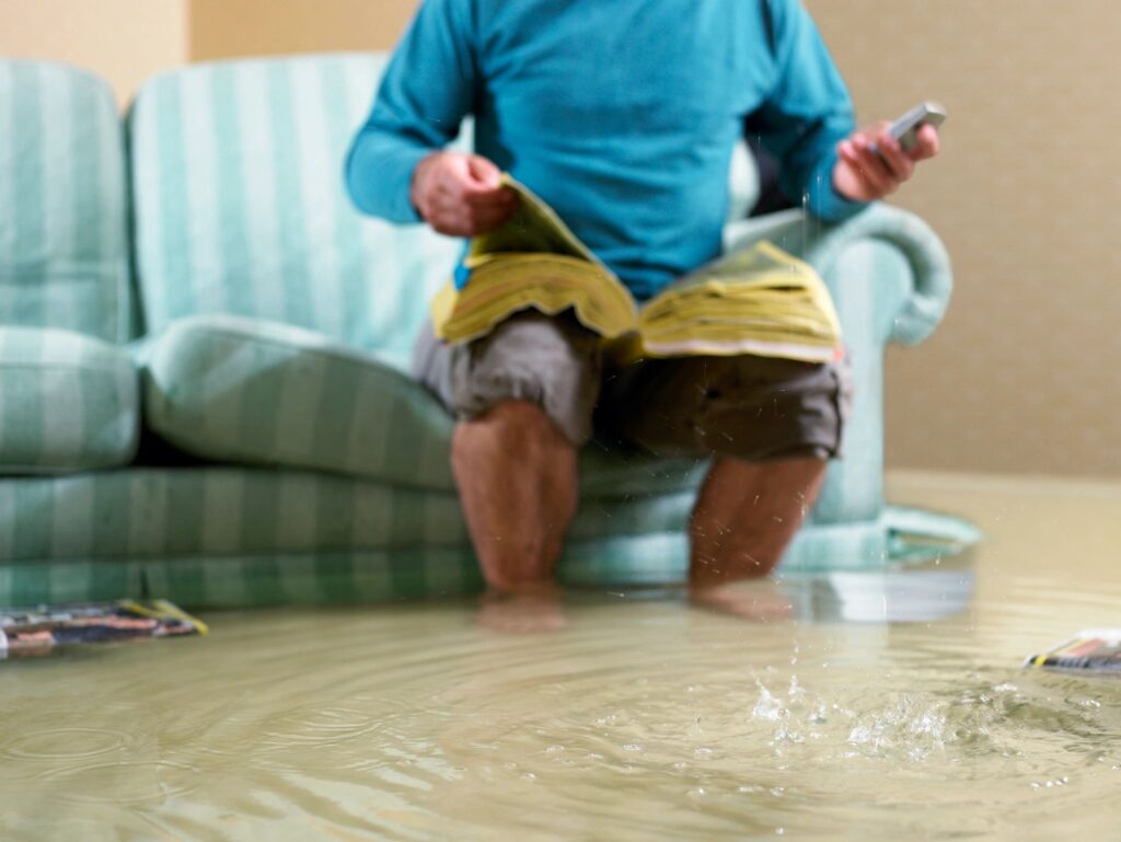 Child playing with water indoors, causing a flood.